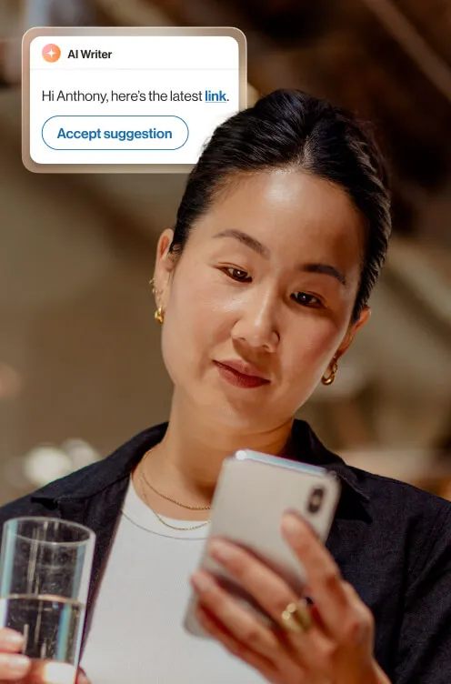 A woman using RingSense AI writer feature to send a message on her phone