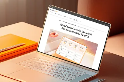 Laptop displaying a RingCentral blog article announcing the latest AI innovations for RingCX, featuring an embedded graphic of a contact center analytics dashboard.
