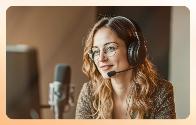 A smiling female online events host with headphones and a standing mic