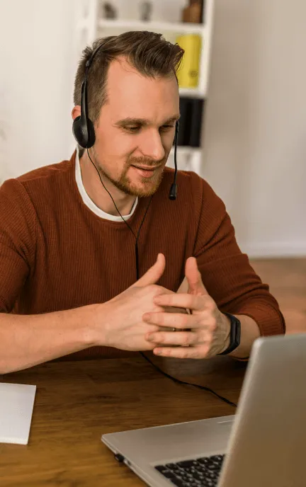 A man attending a video meeting in his home office