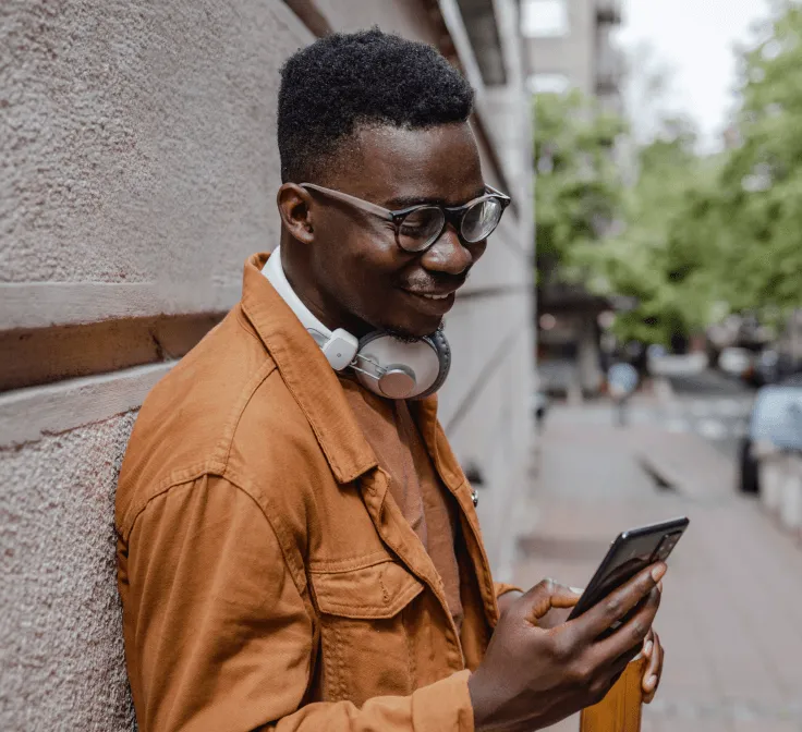 A man checking his phone while outdoors