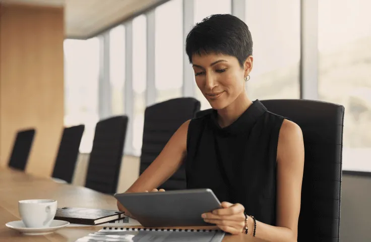 A woman checking documents on her tablet