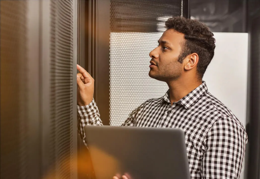 A cybersecurity professional checks on equipment